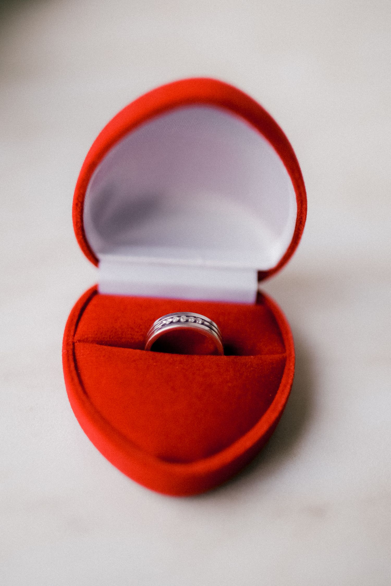 Diamond engagement ring in heart-shaped red velvet ring box.