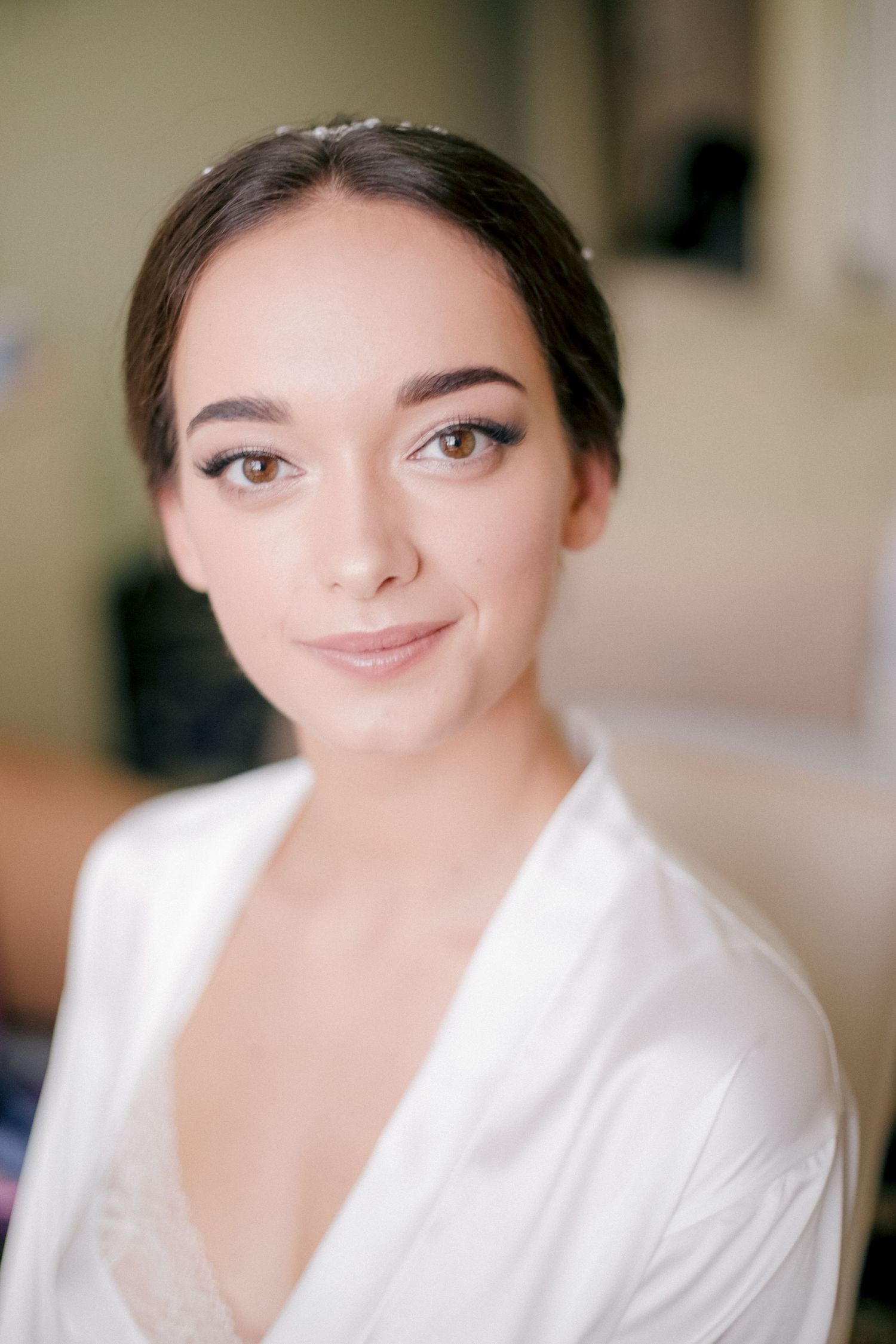 Elegant bridal portrait showing natural makeup and crystal hairpiece.