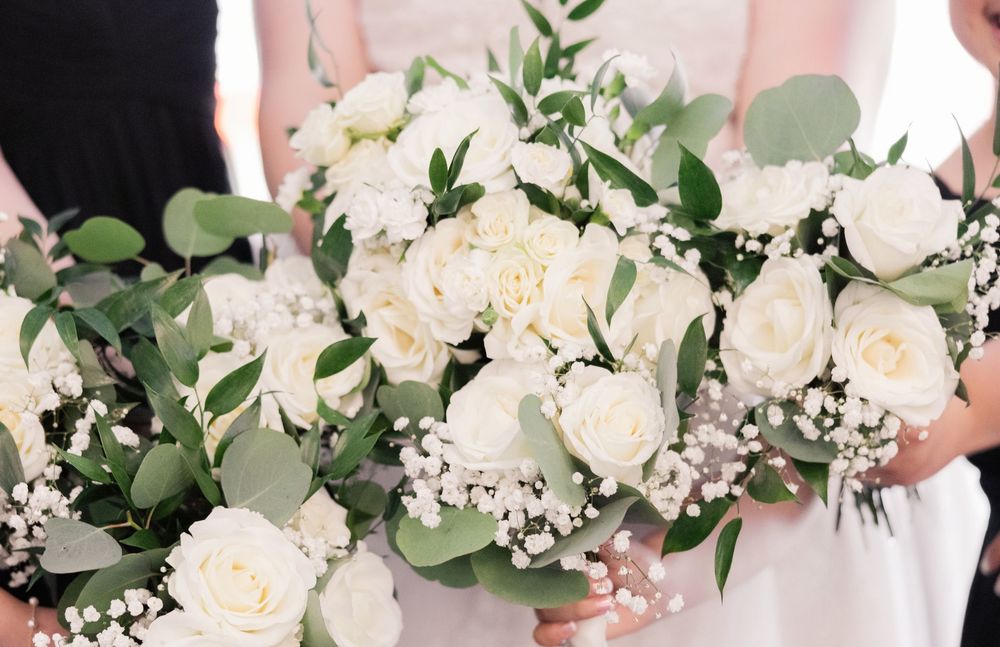 White rose and eucalyptus wedding bouquet with delicate floral arrangements.