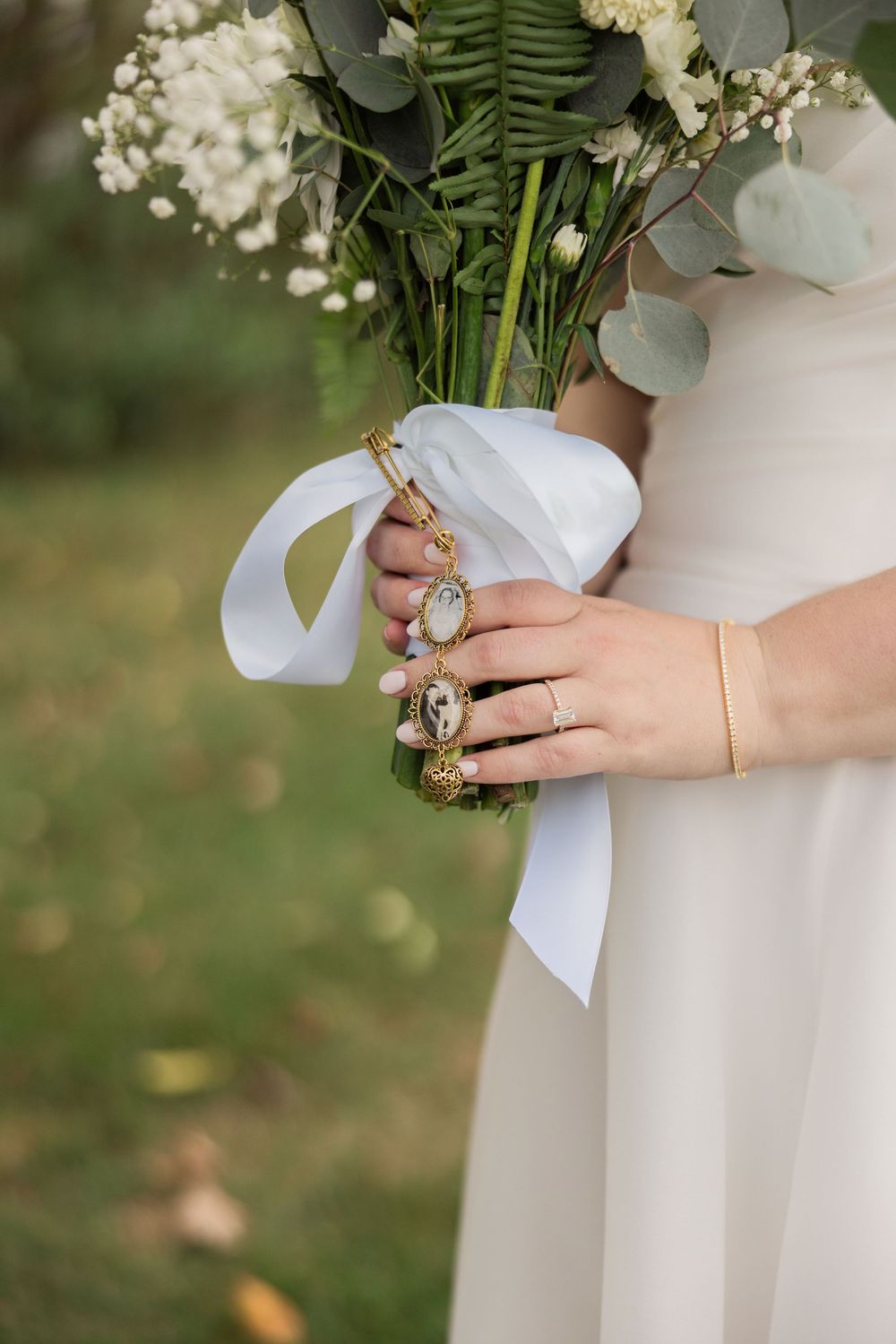 A close-up series of hands wearing vintage-style rings and holding a white fabric bouquet wrap against a blurred green background.