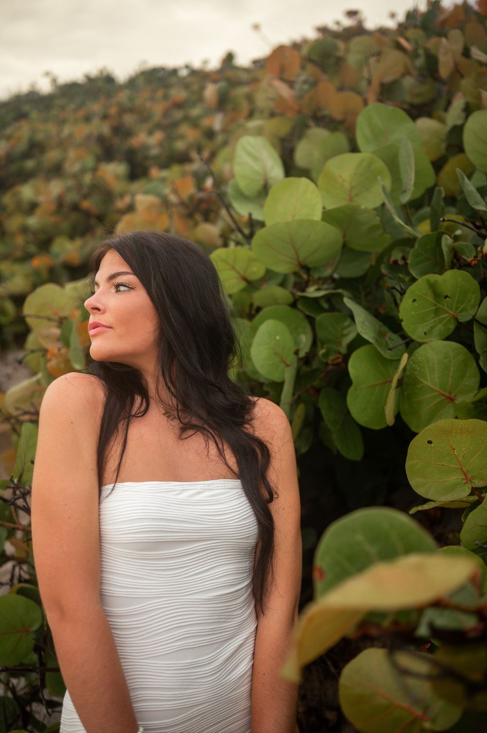 Beautiful Senior girl graduation photoshoot session smiling in white dress sunset beach greenery Melbourne Cocoa Vero Florida Brevard County