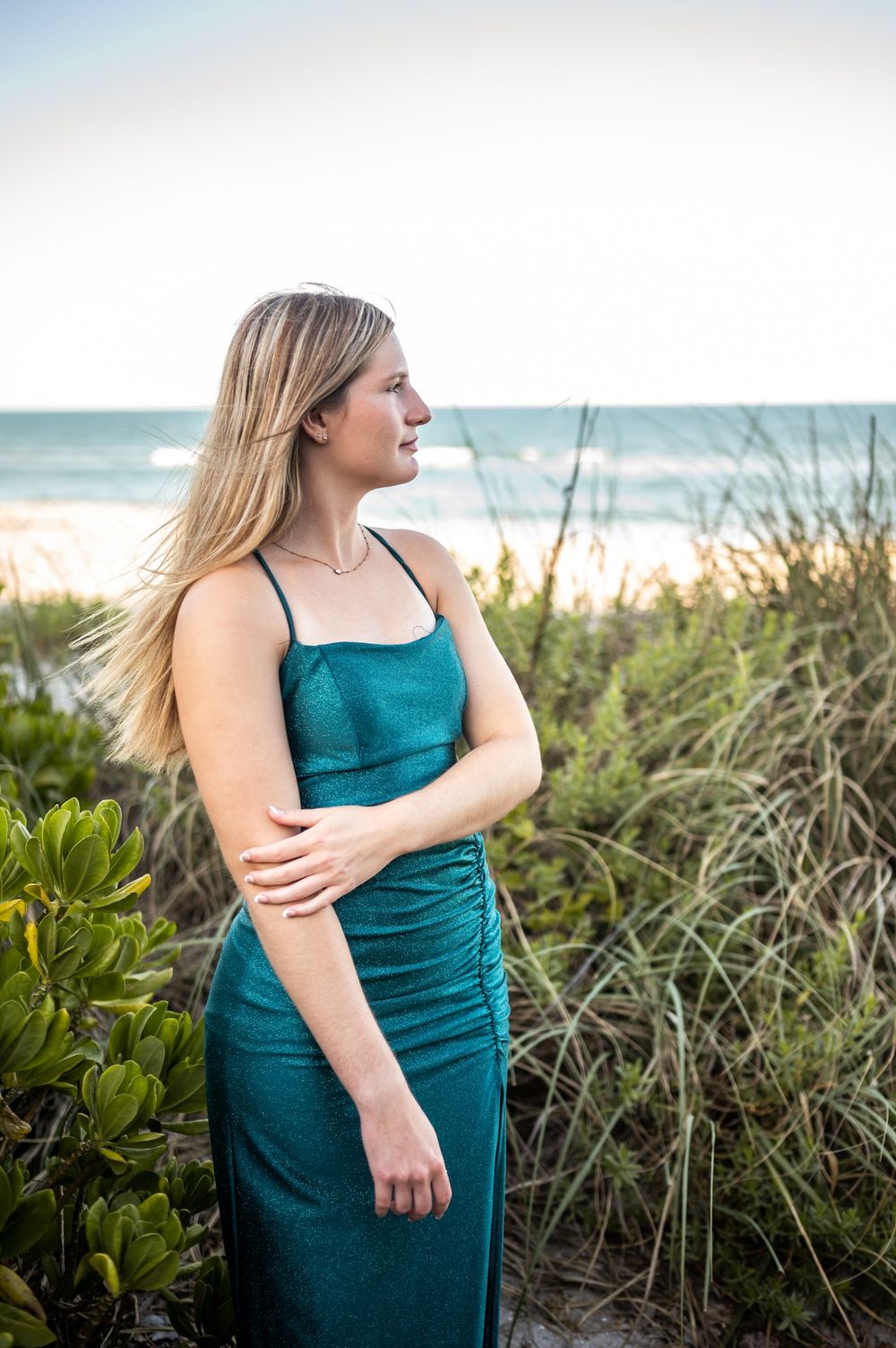 Senior girl graduation photoshoot session smiling candid in green dress sunset beach Melbourne Cocoa Vero Florida Brevard County