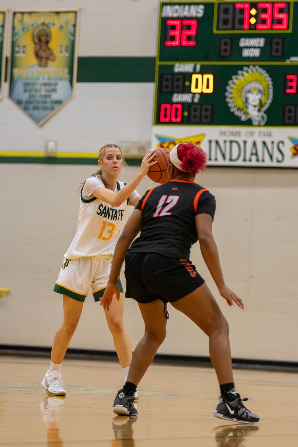 Basketball players battle for control of the ball during a competitive match.