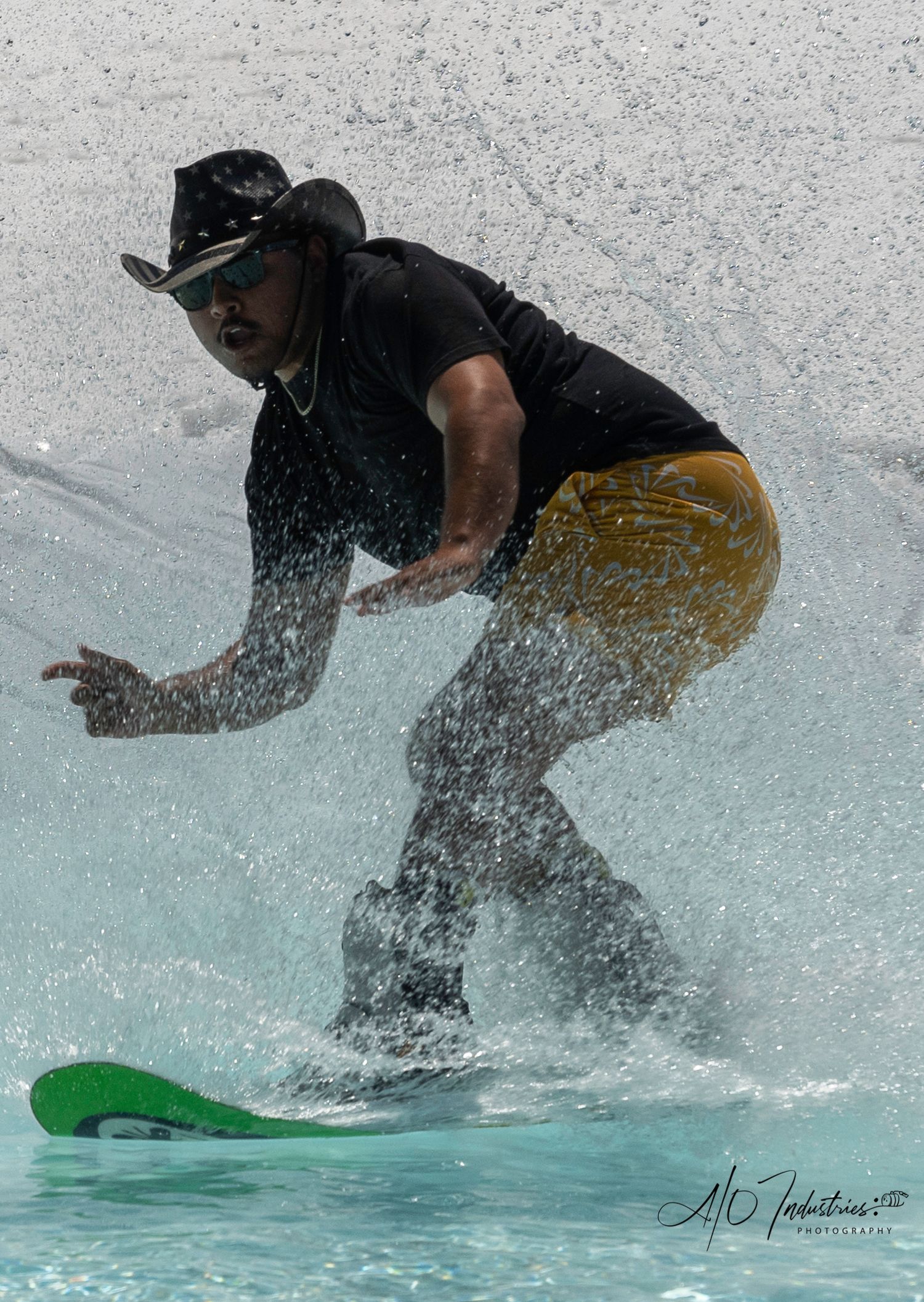 Skier creates splash while crossing pool during winter sports event.