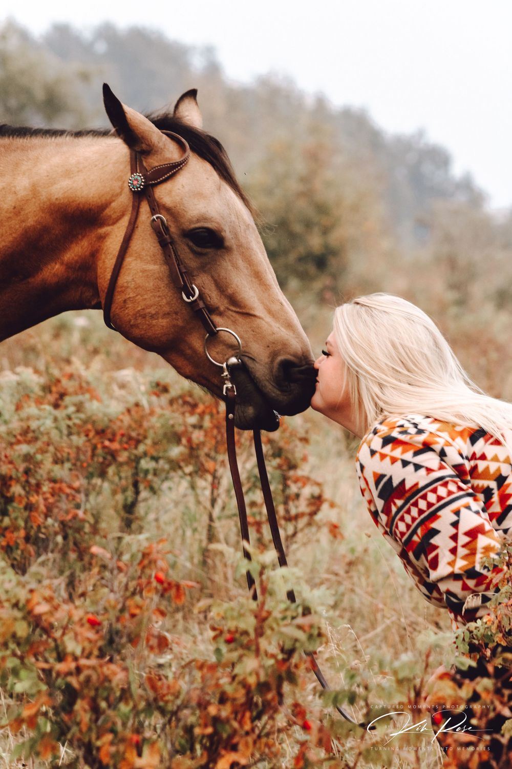 Rider kissing horse as a sign of affection and trust in Northern British Columbia