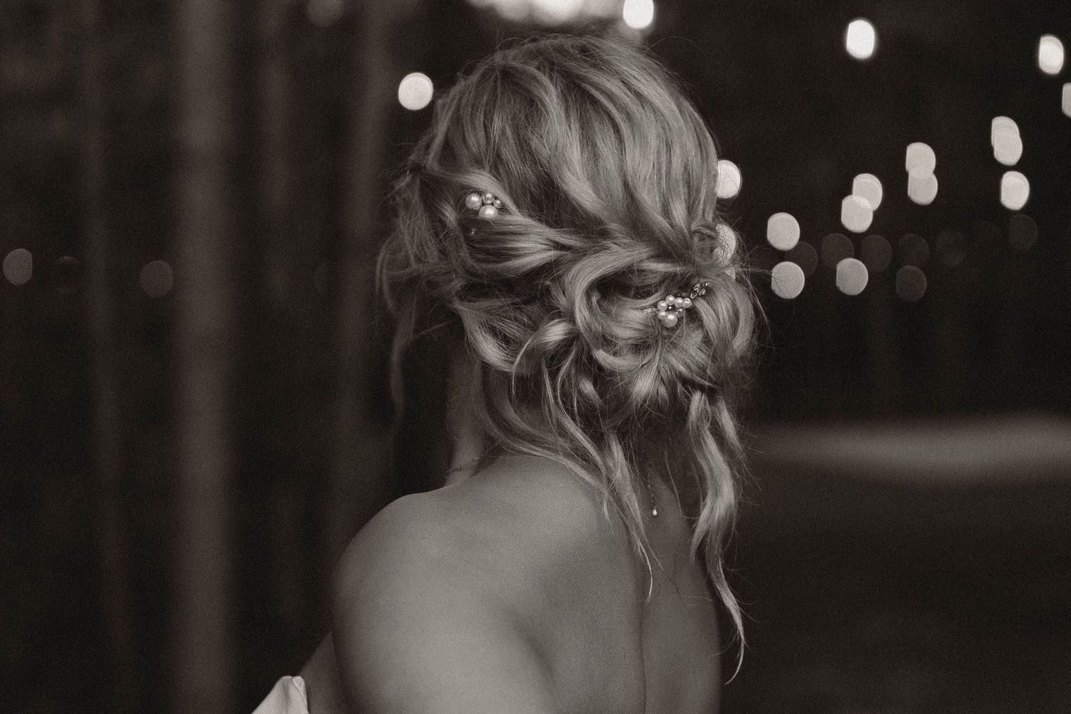 Soft focus black and white wedding photography details with bokeh lighting effects.