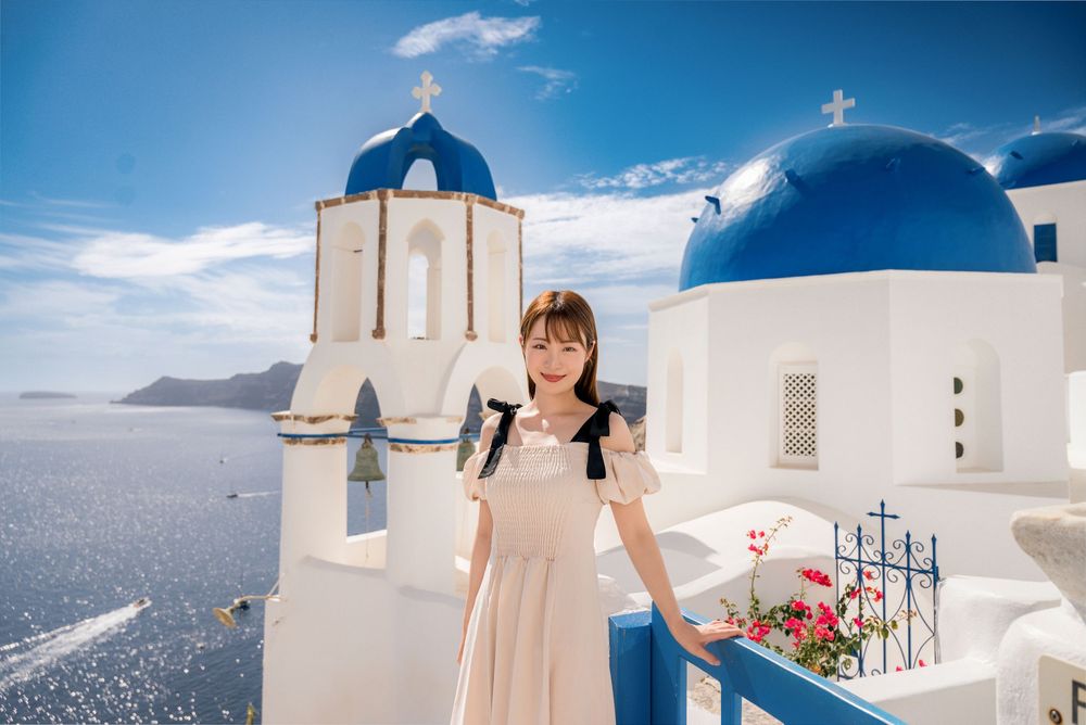 Series of romantic moments captured against Santorini's iconic white architecture and blue domes.