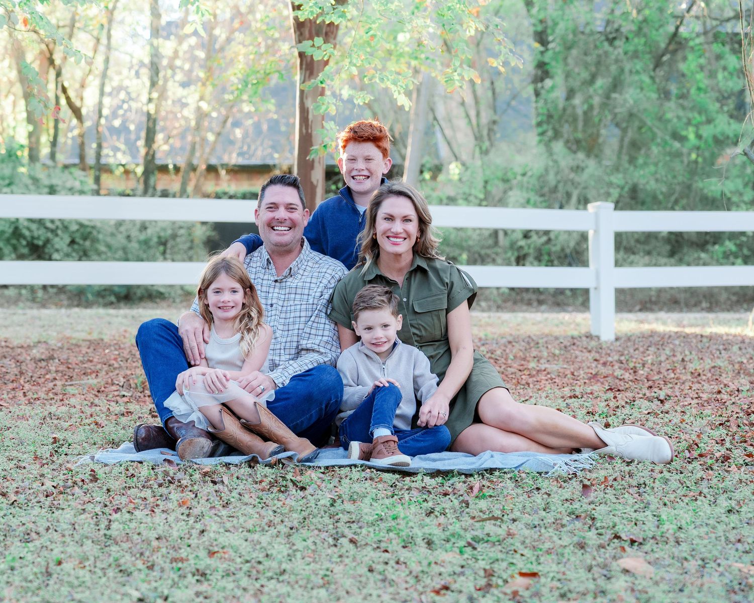 fall family photo session fall photos photography family sitting on a blanket white fence leaves fall colors outdoors golden hour Keller TX