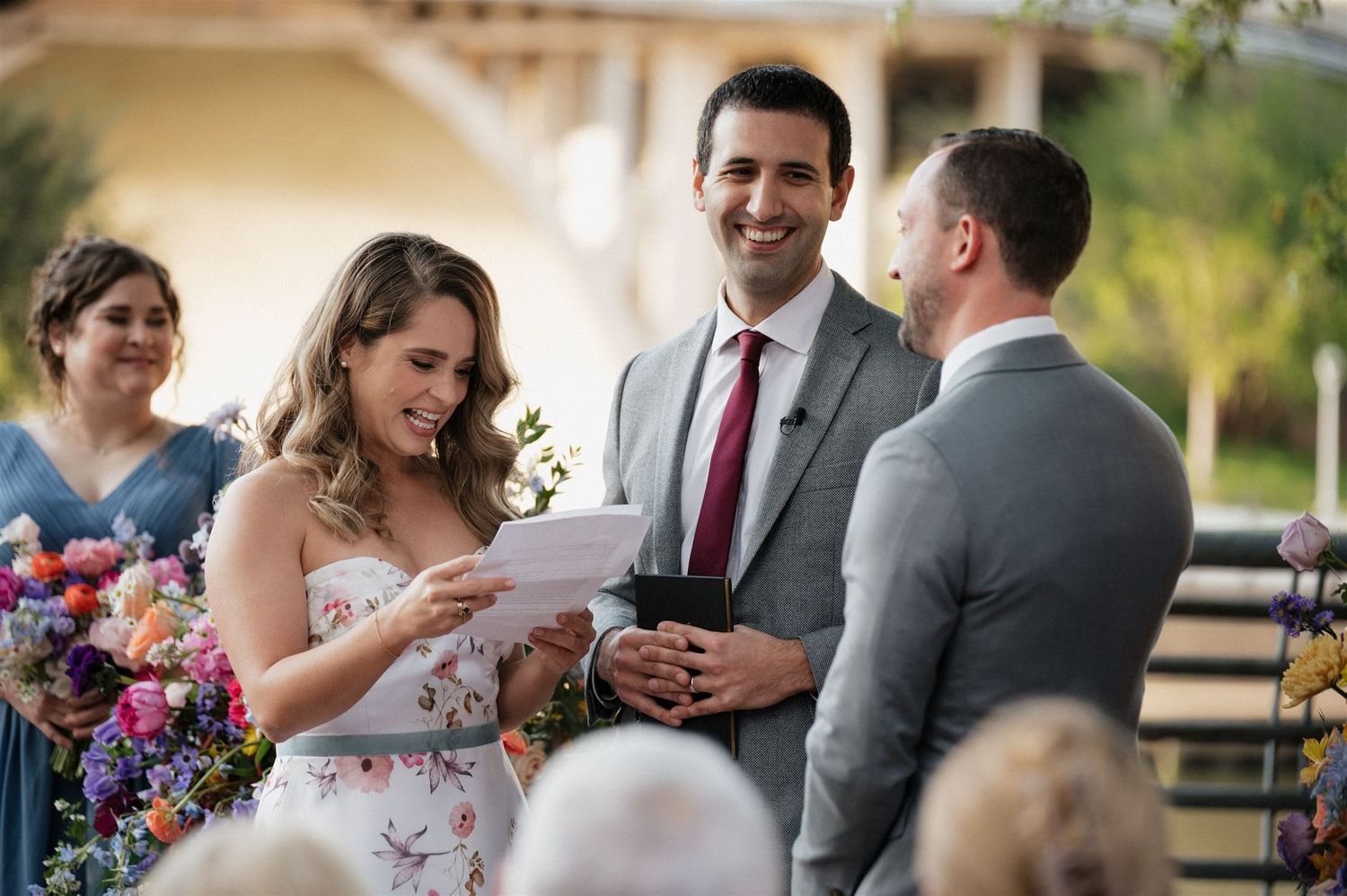 Wedding ceremony in progress with guests watching the exchange of vows.