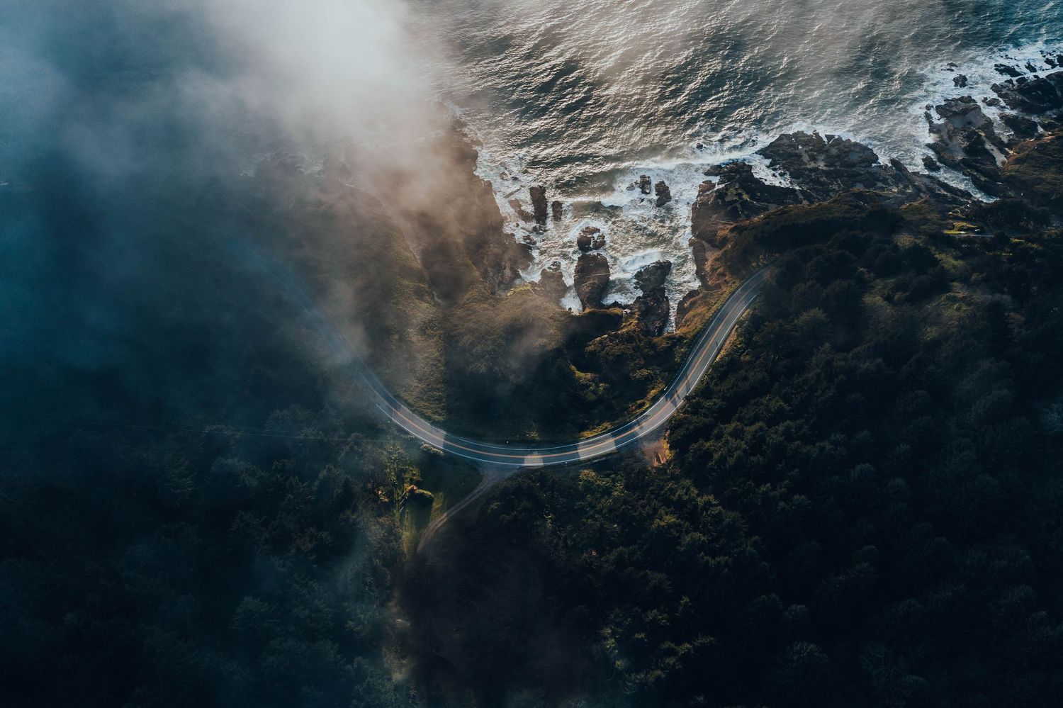 Misty mountain peaks with dramatic clouds rolling across rugged terrain.