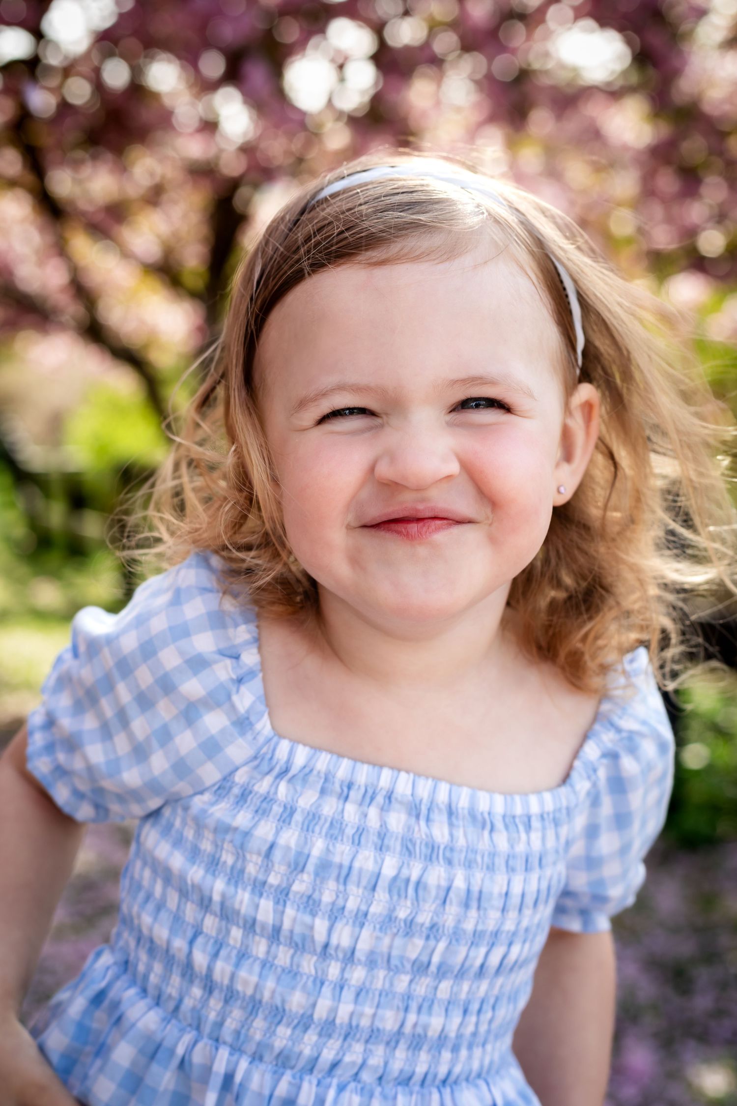 A sequence of close-up shots showing joyful expressions under blooming cherry blossoms.