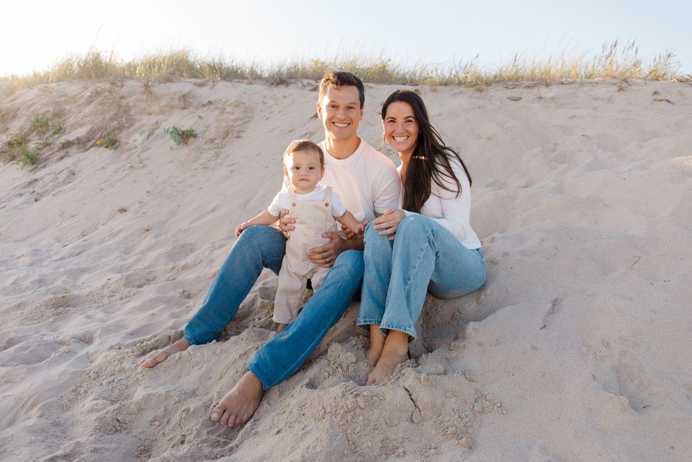 Family spending quality time together on beach sand dunes by Hamptons photographer.