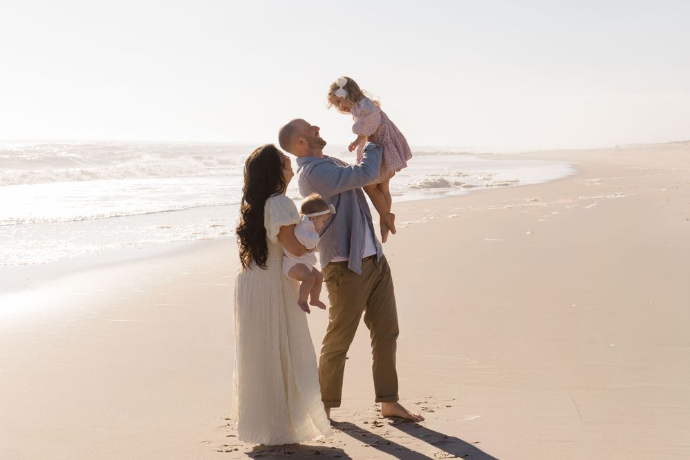 Candid family moments captured during sunset beach photography session by Hamptons photographer.