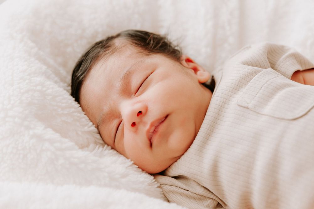 Closeup of peaceful sleeping baby wrapped in soft white blanket.
Altona Family Photographer Melbourne