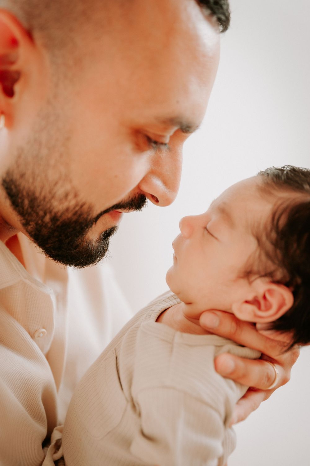 Intimate moment between parent and sleeping newborn in soft lighting.
Altona Family Photographer Melbourne
