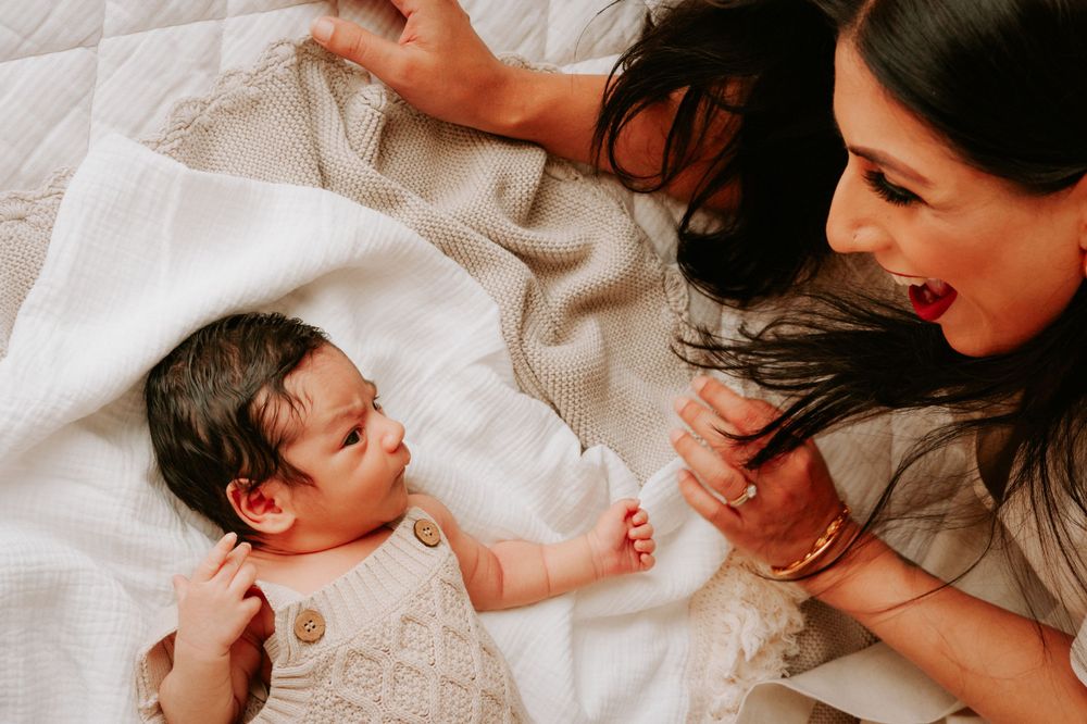 Parents and newborn sharing tender moments on white bedding.
Altona Family Photographer Melbourne