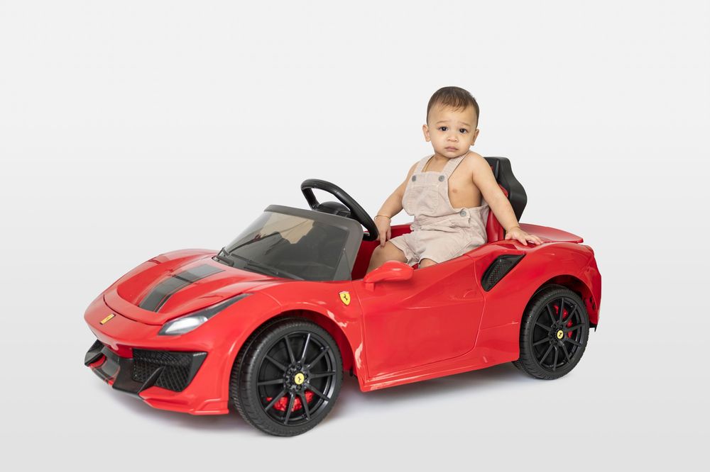 Red toy sports car shown from different angles with child playing.