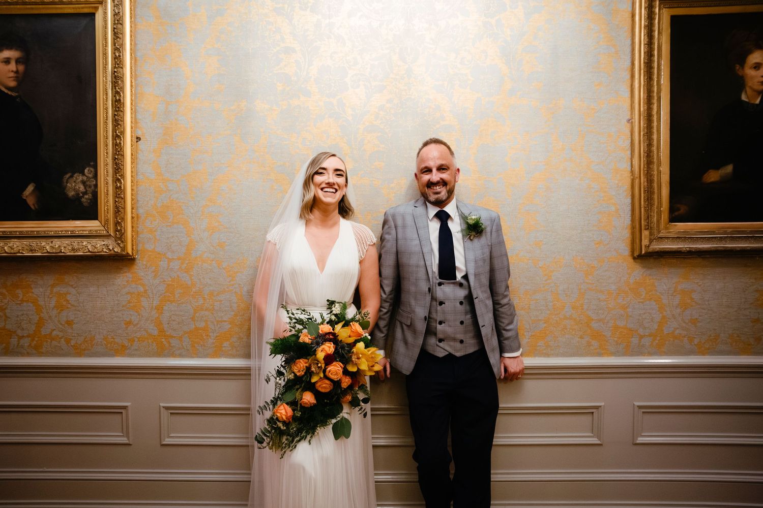 Celebratory moment at wedding reception with raised hands and joyful expressions.