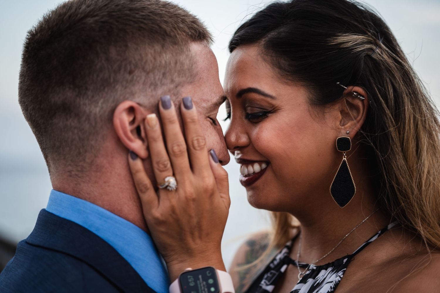 Intimate close-up of couple sharing tender moment outdoors.