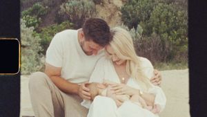 Couple sitting together outdoors sharing a tender moment.