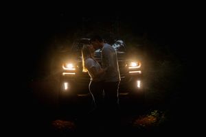 A series of dark cinematic frames showing a drone with lights flying through dimly lit indoor spaces.