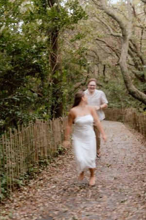 A sequence of photos showing someone running through a leaf-covered woodland path in a white dress.