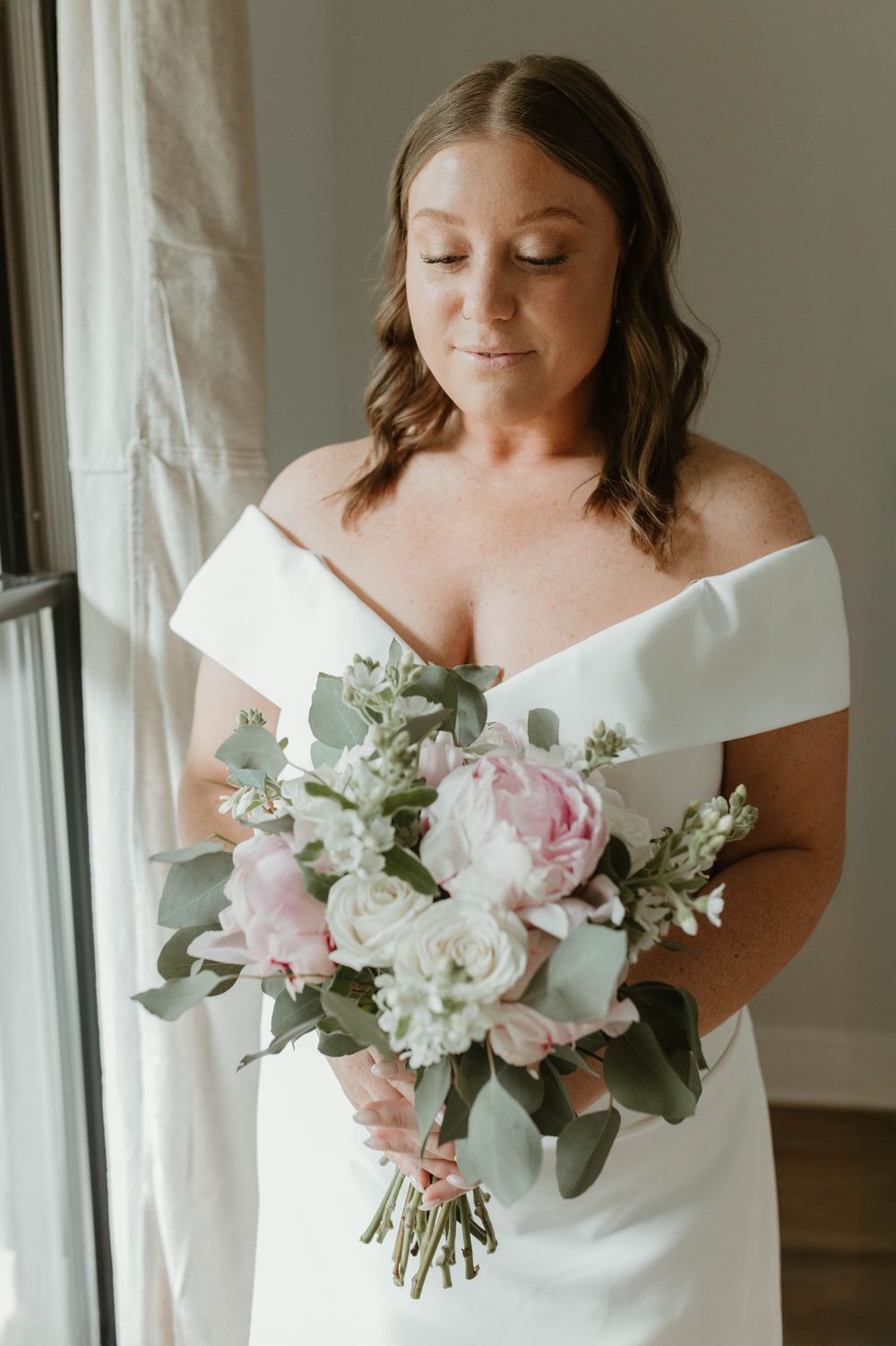 Close-up shots of a white wedding dress and delicate pink and white bouquet.
