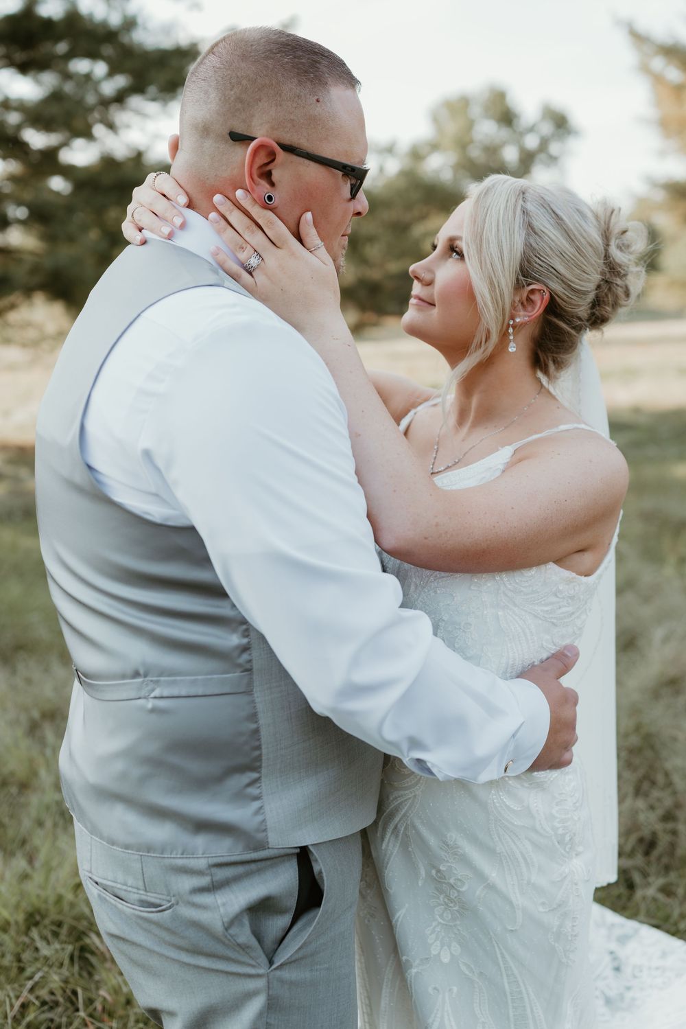 Romantic wedding couple sharing intimate moments in an outdoor setting.