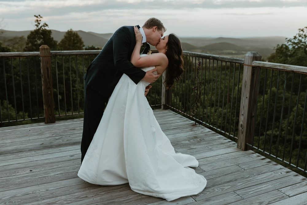 Romantic wedding photos on a wooden deck overlooking mountain views.