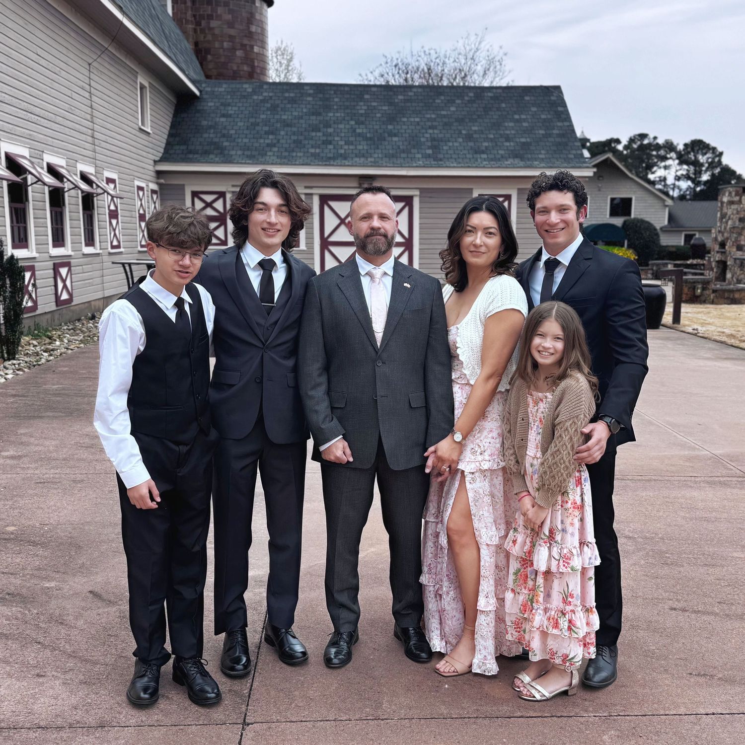 Wedding party poses creatively showing only their legs and feet lined up in a row on a paved walkway.