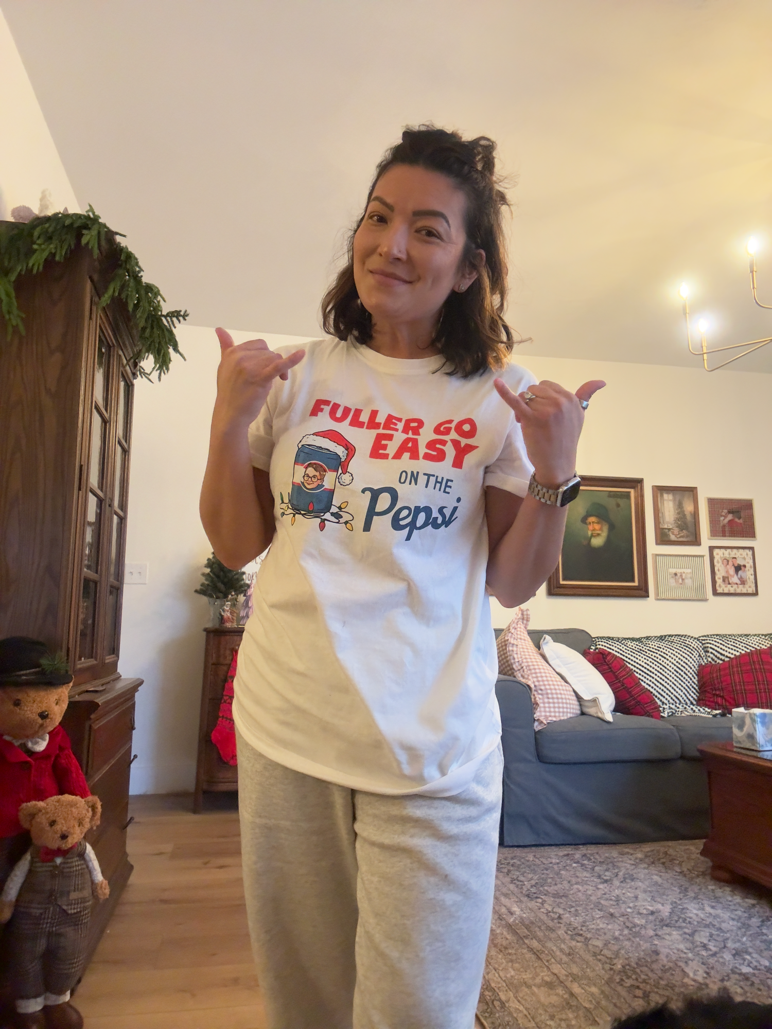 A series of photos showing someone wearing different white t-shirts with text slogans in a living room setting.
