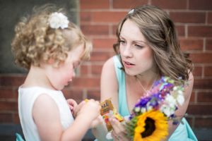 A tender moment between two people sharing sunflowers and colorful summer blooms.