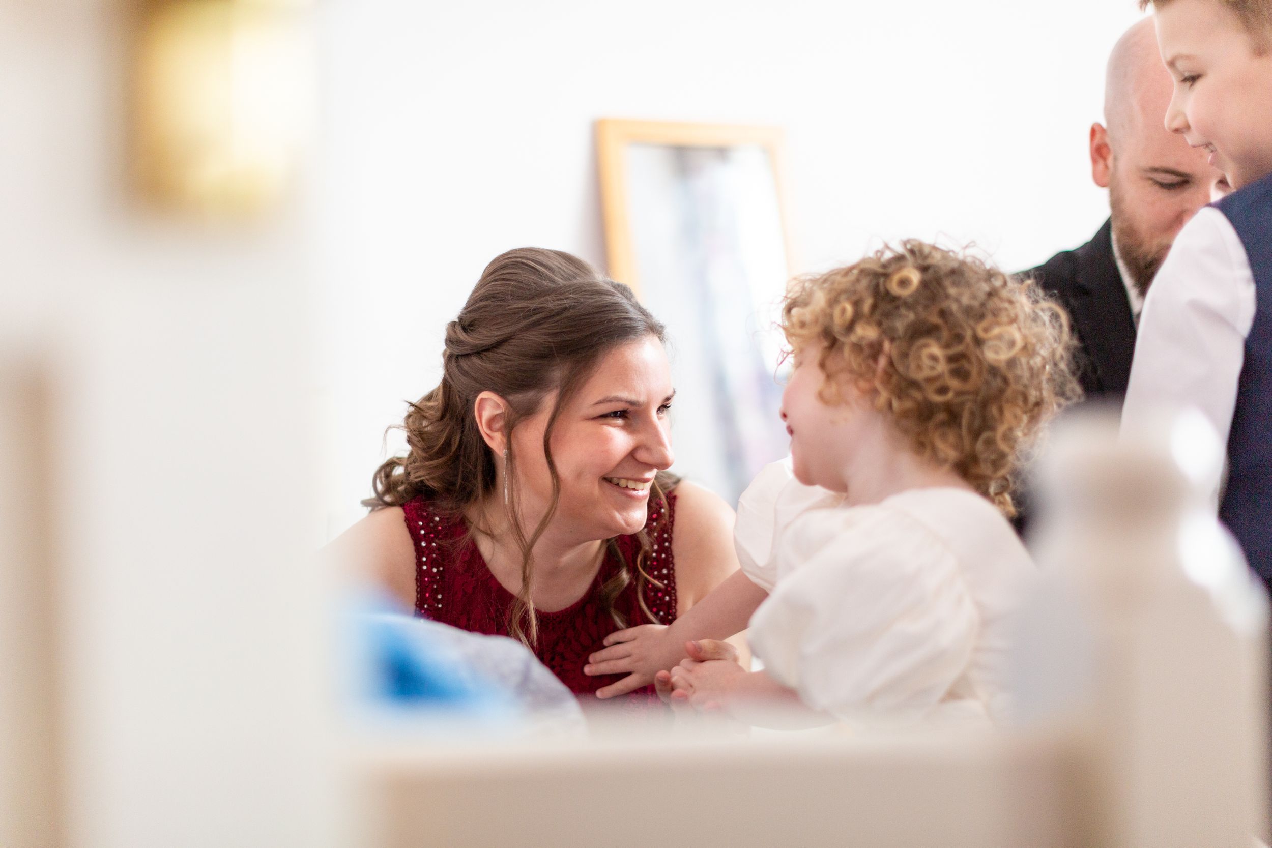 Joyful interaction captured during a formal indoor celebration.