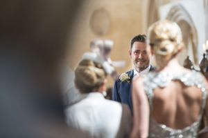 Intimate wedding ceremony moment captured through a blurred foreground.