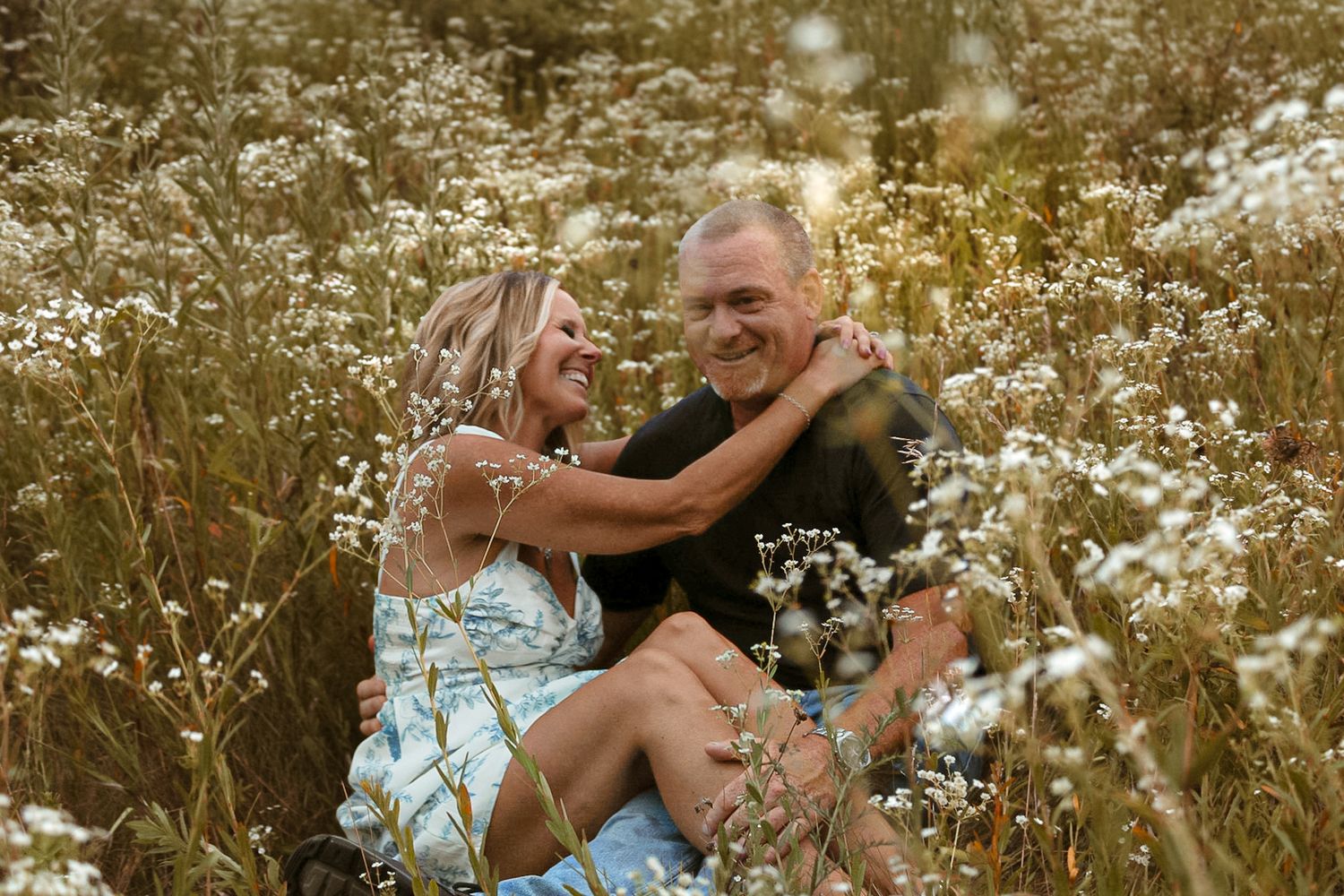 Intimate couple portraits among blooming wildflowers in golden light.
