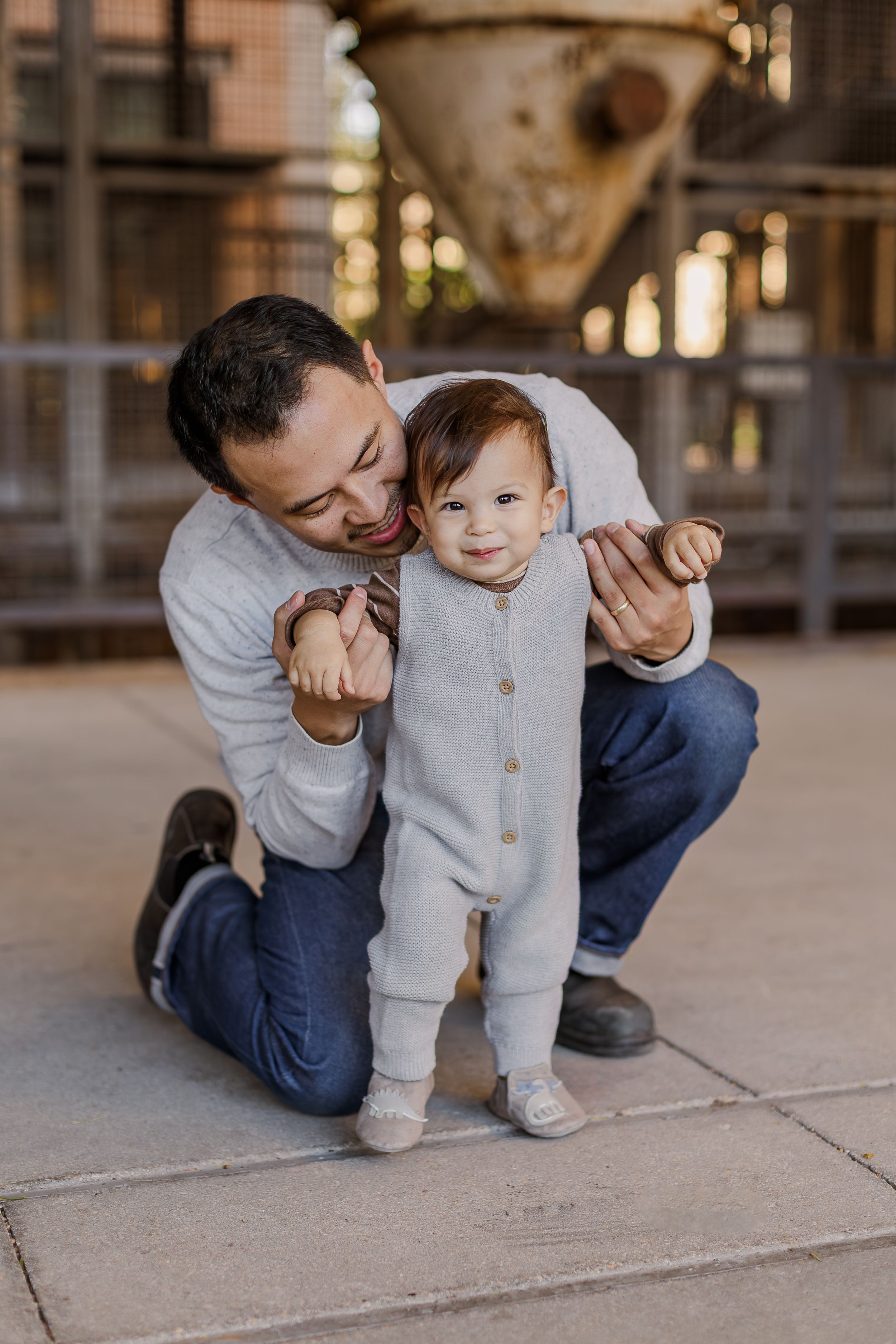 A series of candid moments showing a parent and baby interacting playfully on a concrete surface.