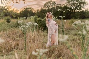 A dreamy golden hour photoshoot in a wildflower meadow with soft natural lighting and tall grass.
