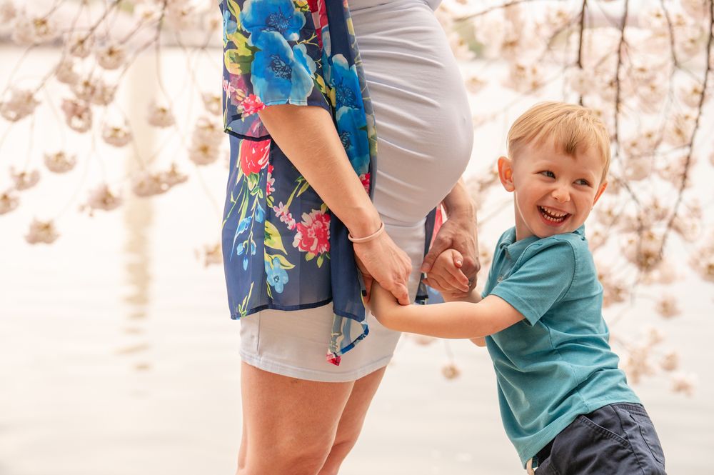 Candid interaction shows special moments between a parent and laughing child playing together outdoors.