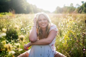 A joyful summer portrait in a wildflower meadow during golden hour.