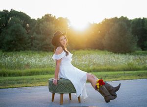 Clarkston Michigan senior photographer capturing high school senior portraits. Senior girl in white dress, sunset behind her