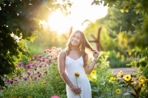 Romantic garden photoshoot with sunflowers and wildflowers during sunset.
