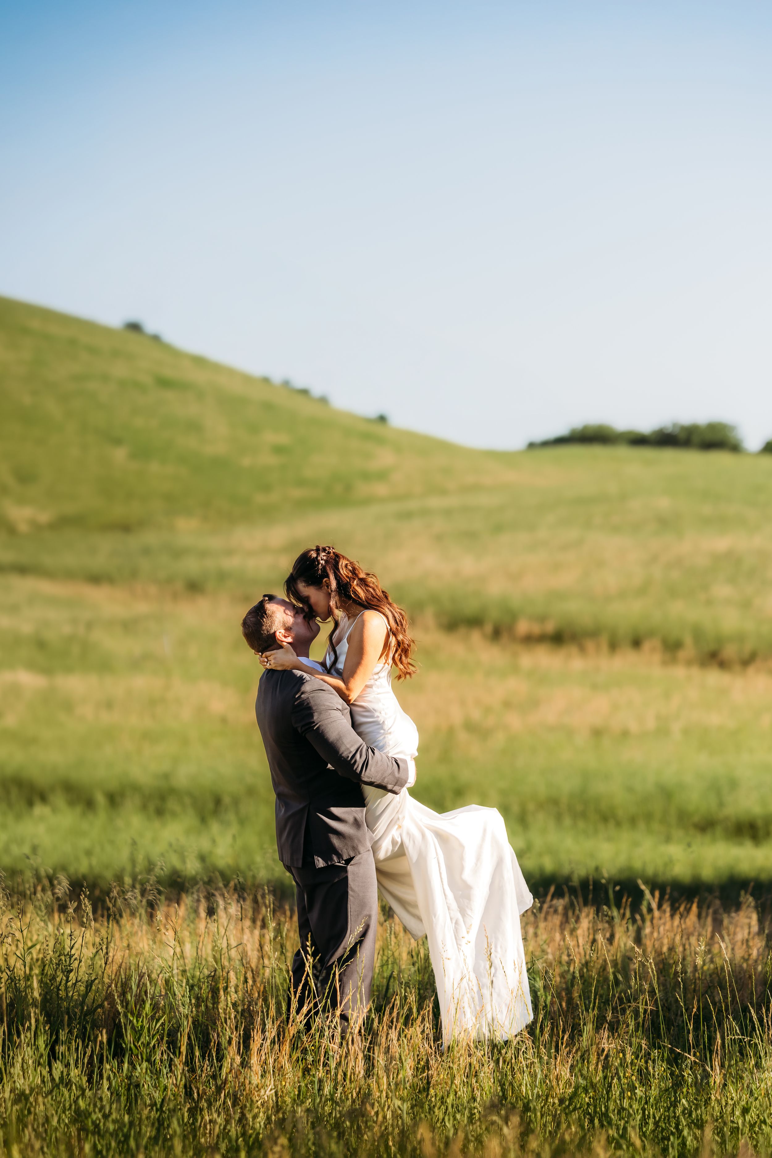 A captured elopement in Cheshire, CT with sun falling on a kissing newlywed couple