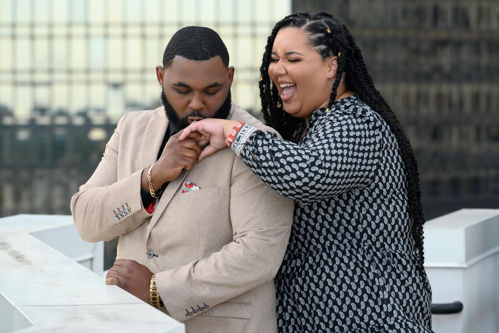 A couple shares tender moments in an outdoor photo sequence wearing black and beige outfits.