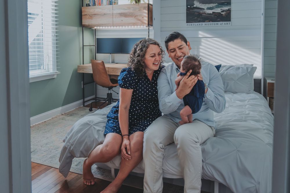 Couple sitting on bed sharing a tender moment together.