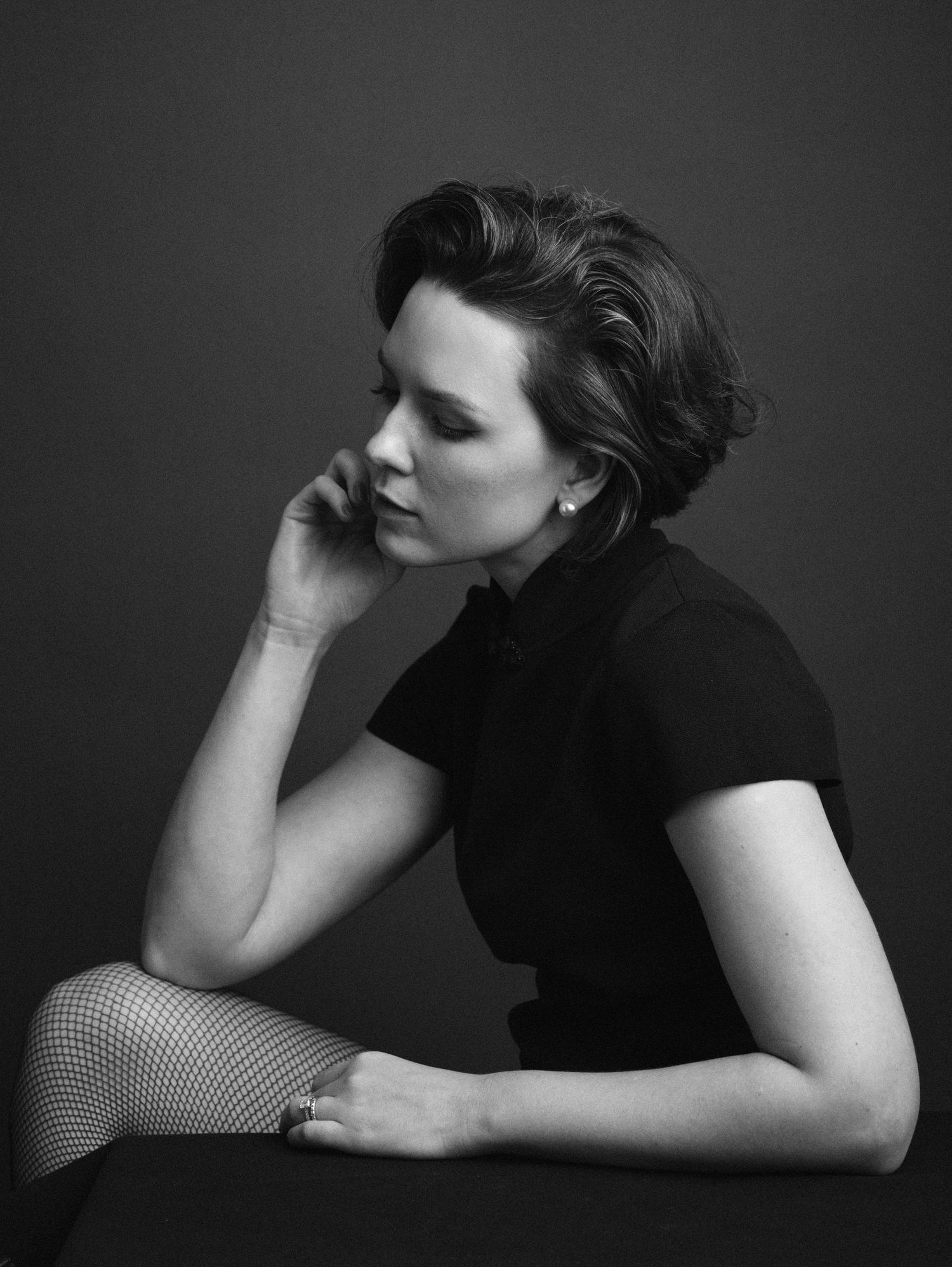 Artistic black and white portraits showing reclining poses with dramatic shadows.