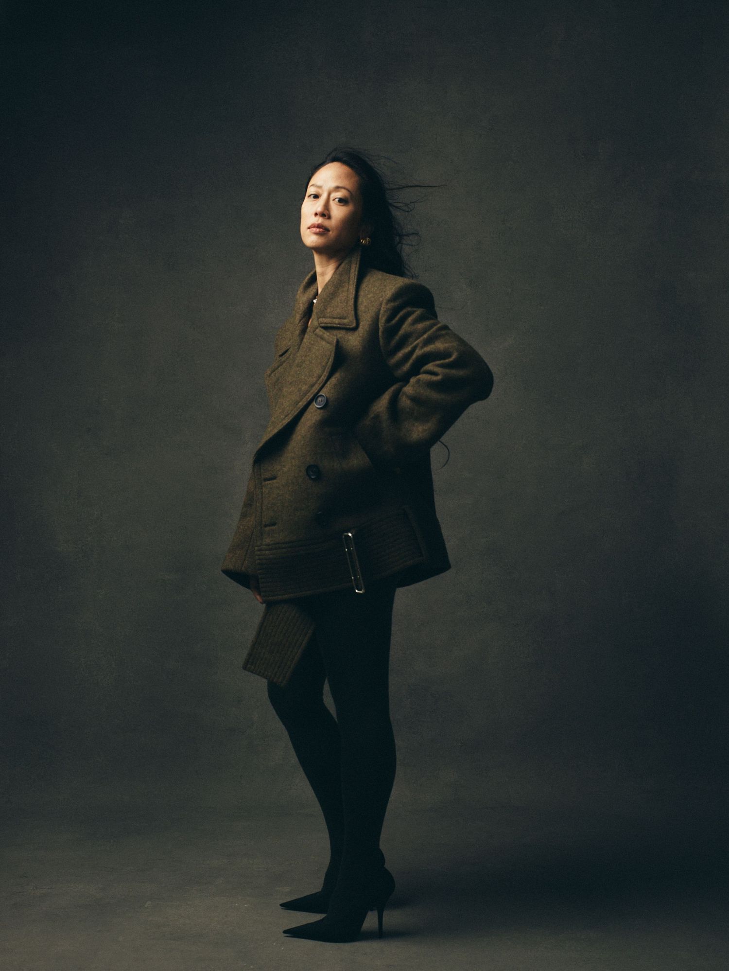 Dynamic fashion portraits showing movement and poses in dark tailored clothing.