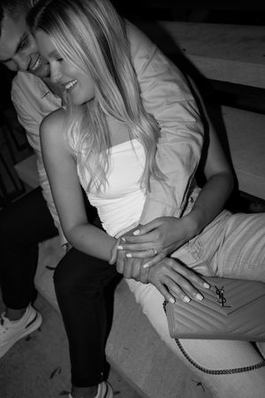 Intimate black and white photograph of a couple sharing a tender moment.