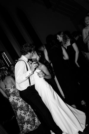 Black and white wedding reception photos showing couples dancing together in an intimate setting.