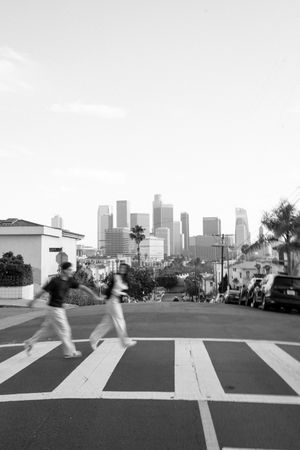 Black and white cityscape with urban buildings and walkways across multiple frames.