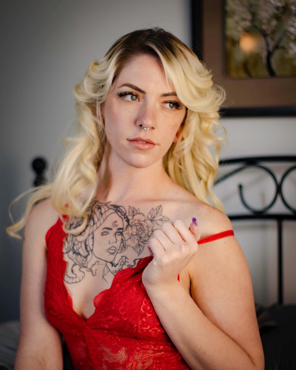 woman on bed pulling down strap to bra